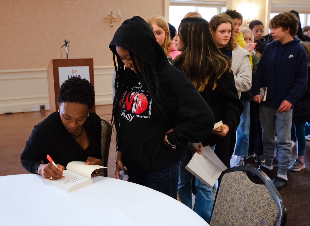 Margot Lee Shetterly signing copies of her book for Buford Middle School and Burley Middle School students. 