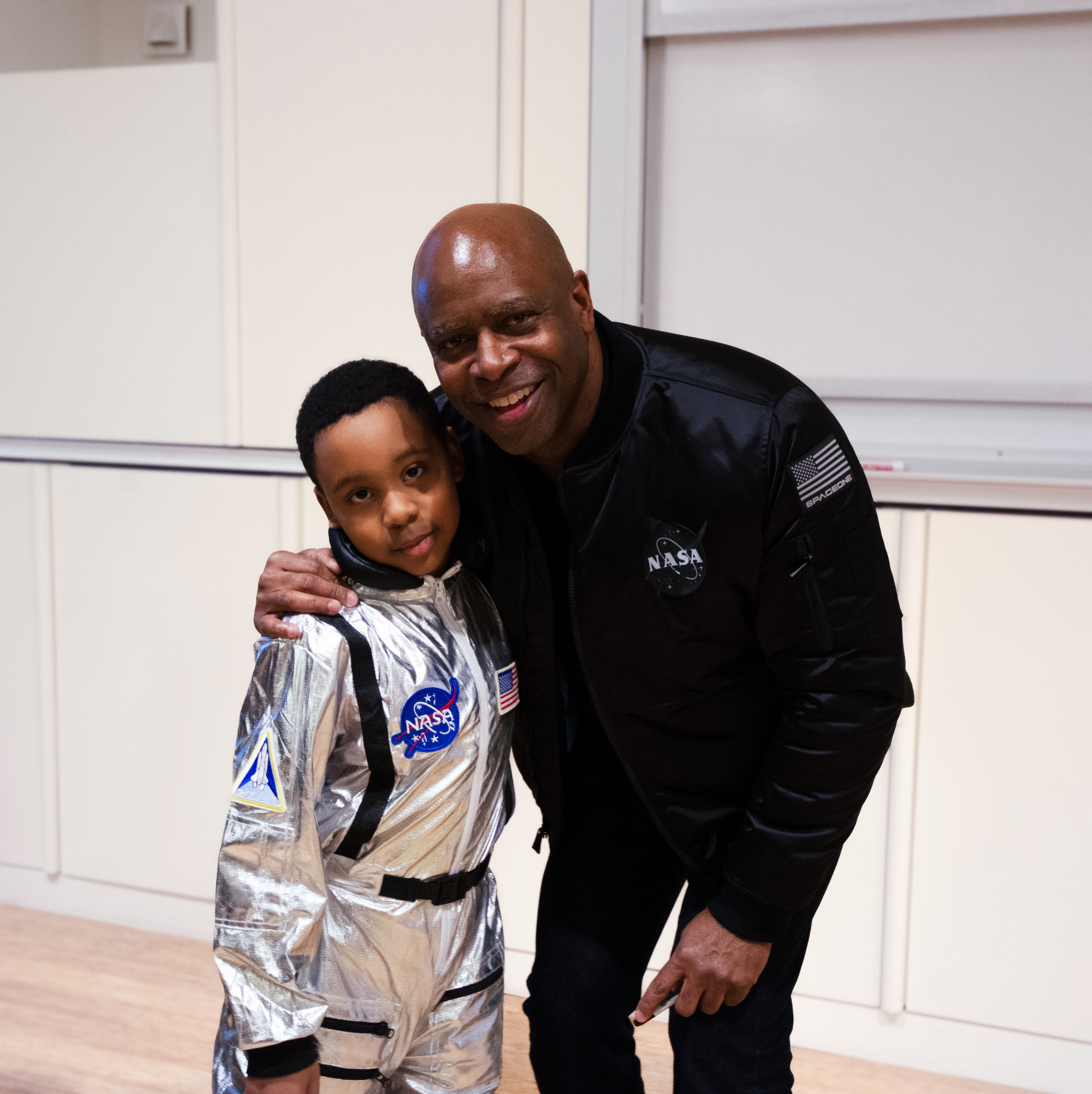 Leland Melvin and a future astronaut pose for a photo together. 