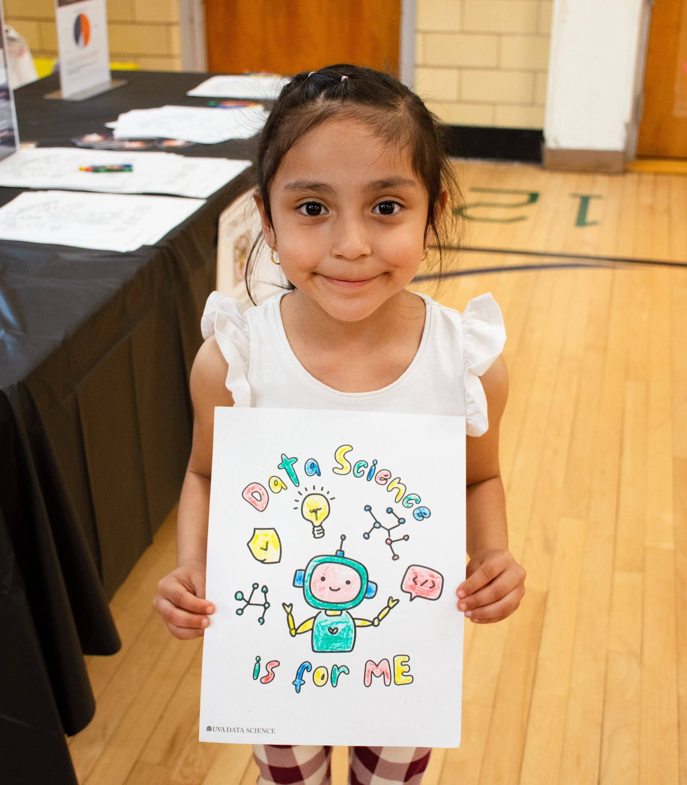 Little girl holding "data science is for me" sign.