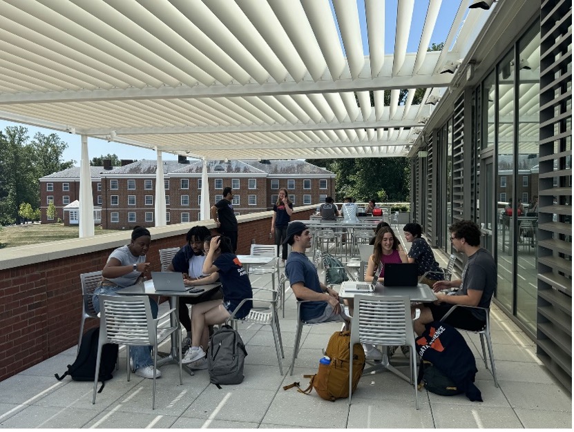 UVA Data Science building terrace on fourth floor with students at tables enjoying the day