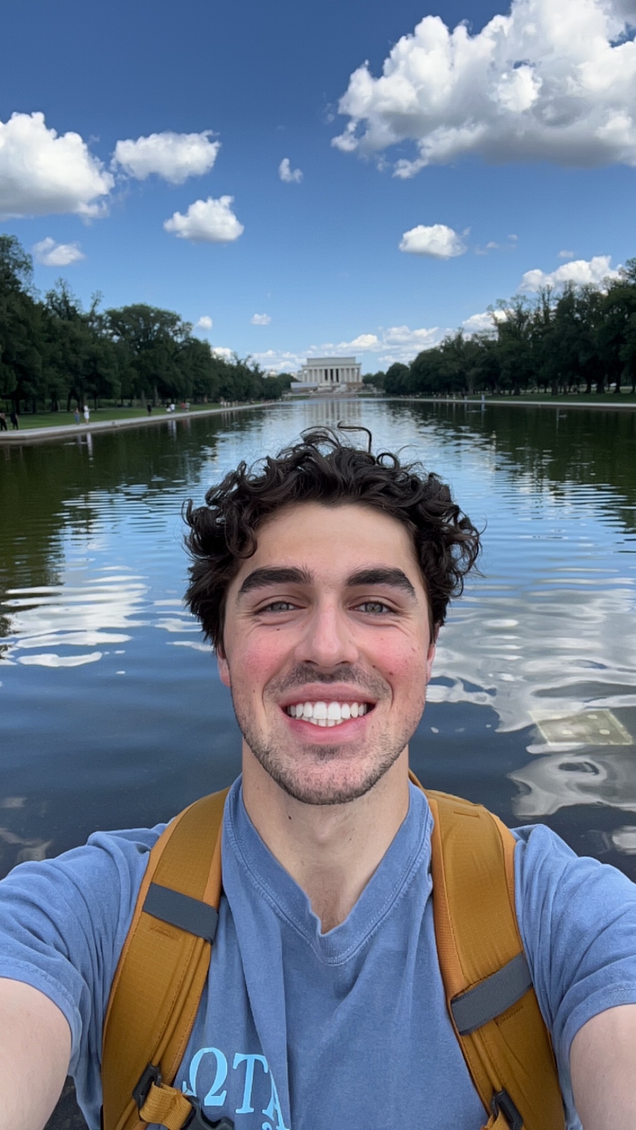 Trenton Slocum smiles for the camera in front of the lincoln memorial