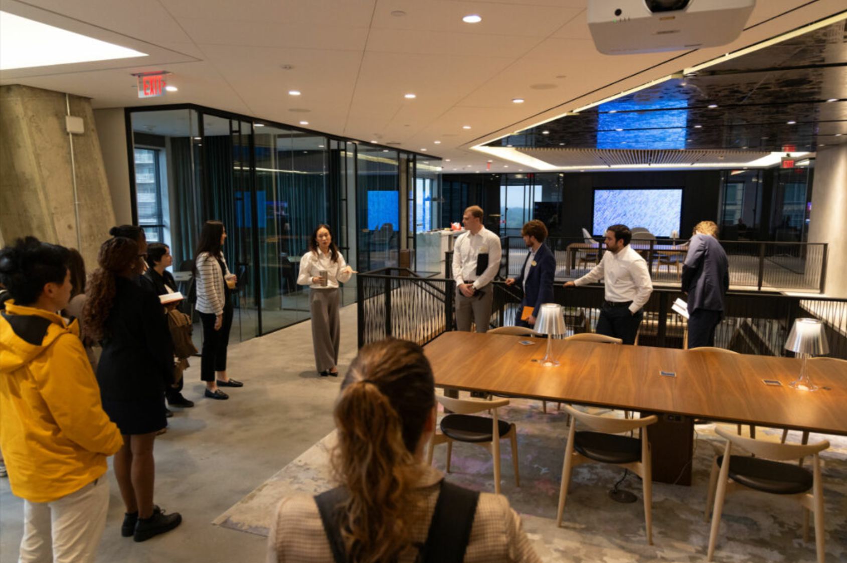 A Real Estate trek given by AvalonBay Communities in their Ballston, Virginia headquarters. A room of people gather around, listening. 