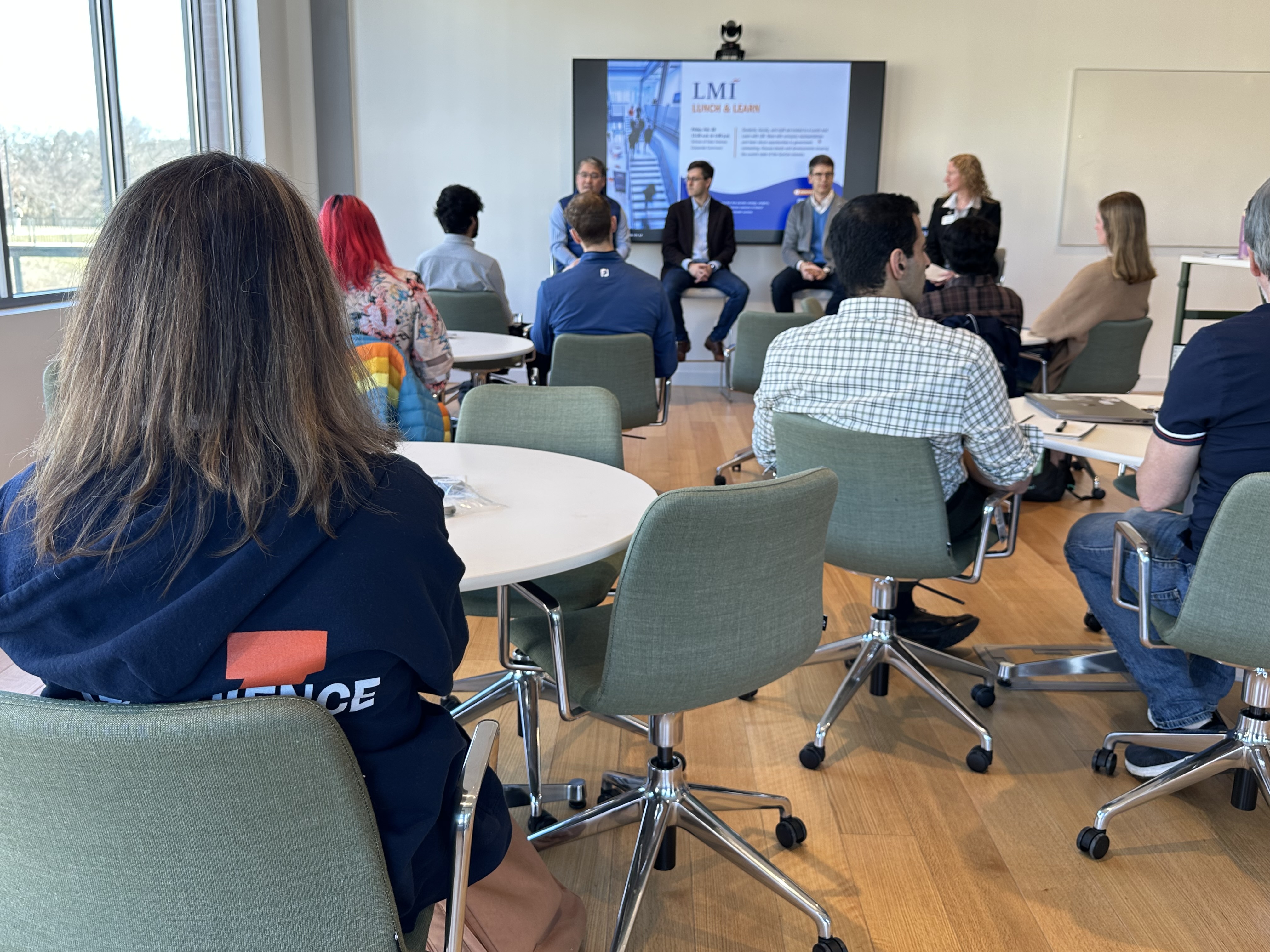 Photo of the fireside chat panelists and attendees at LMI Day 2025.
