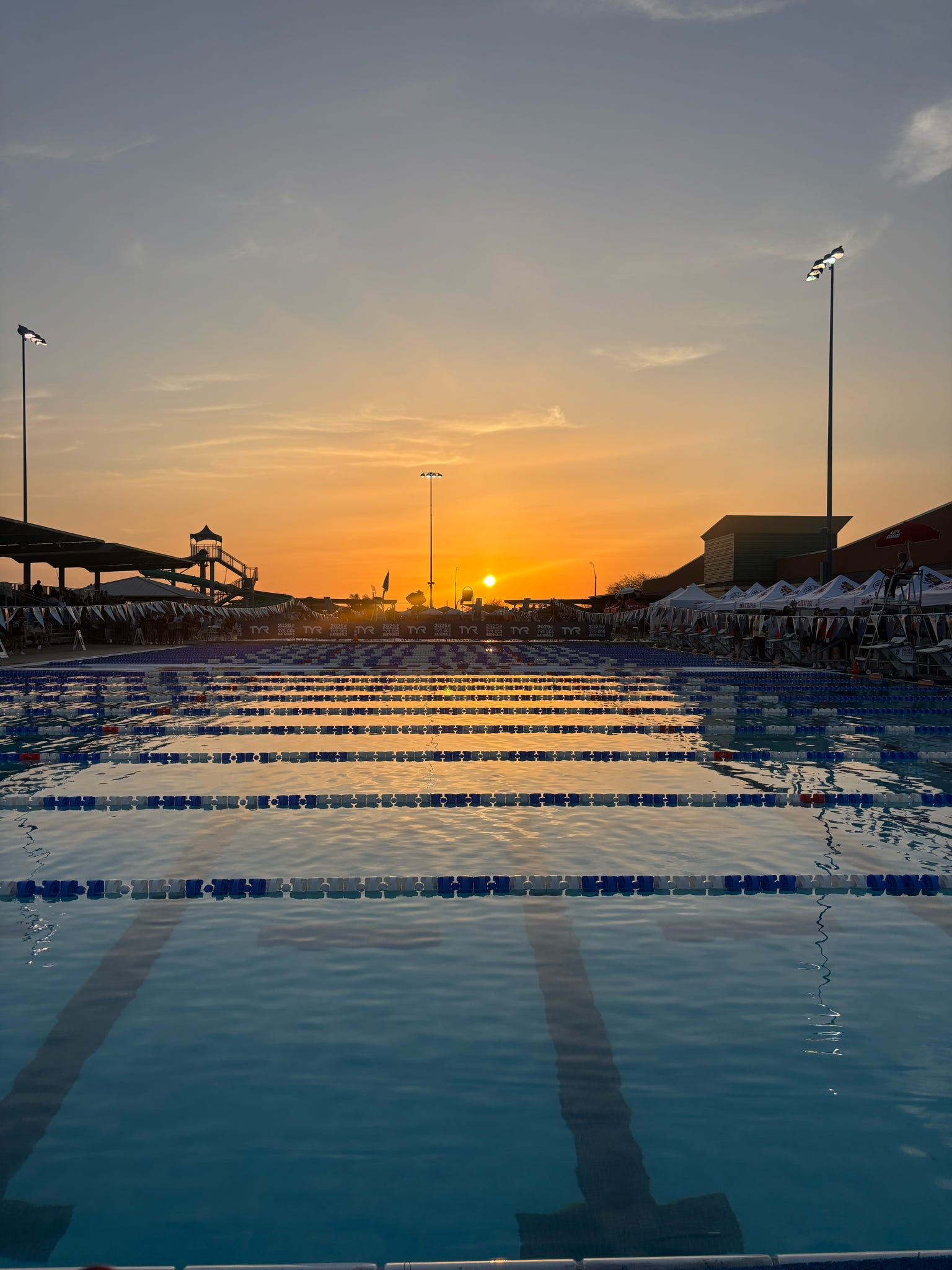 A stunning sunrise photo of pool lanes touched by the amber light of the sun. 