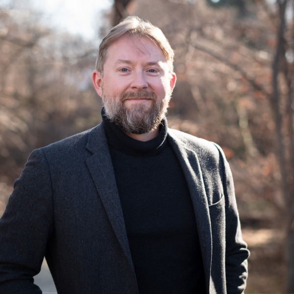 Headshot of Aaron Martin standing in an outdoor environment.
