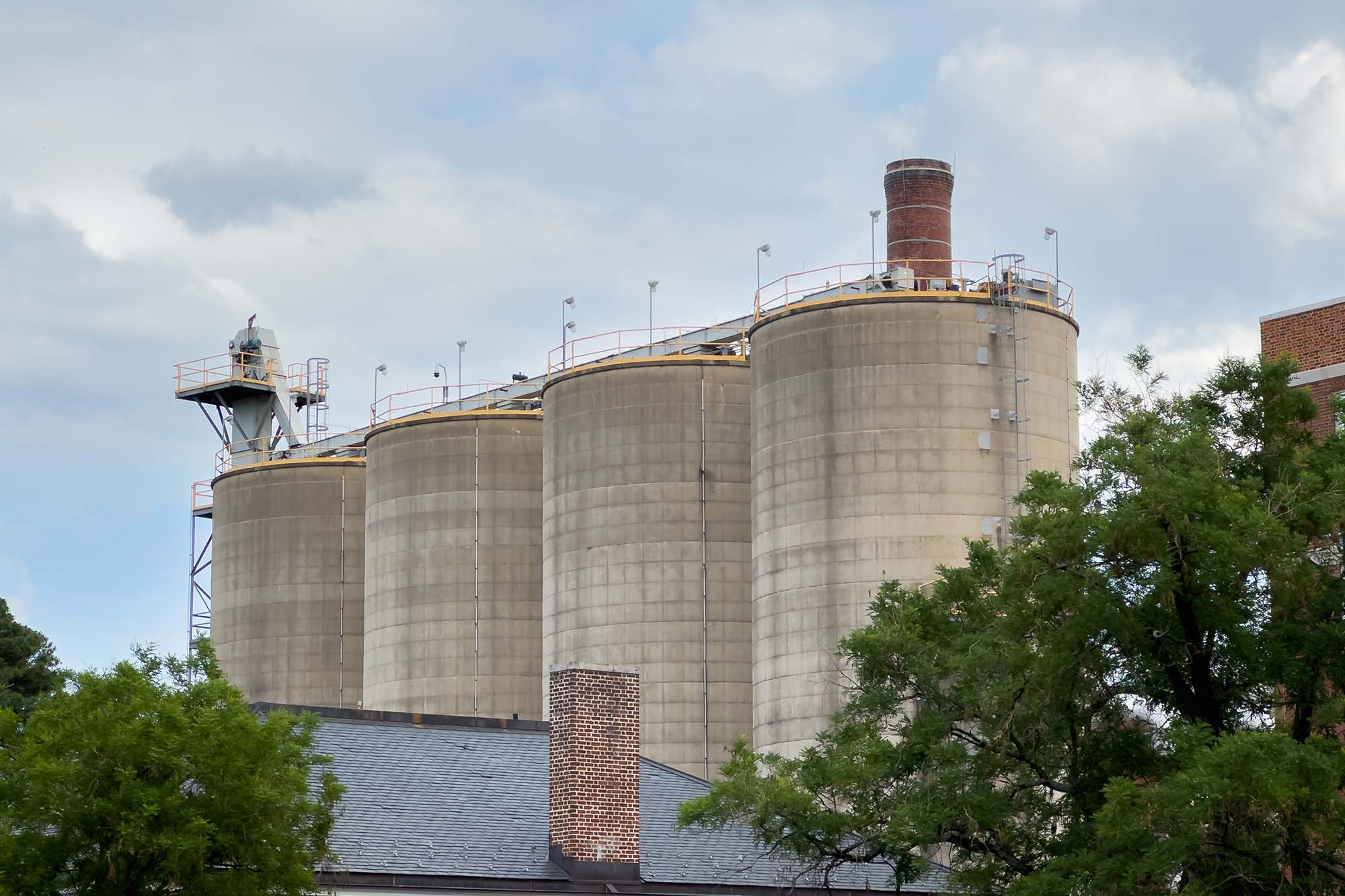 Four large concrete coal silos rise from the Main Heating Plant.