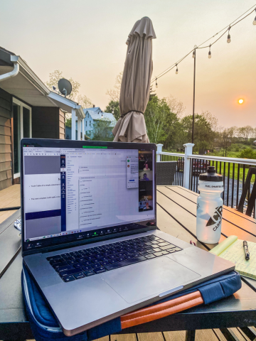 MSDS Online assignment on laptop computer outside on deck at sundown