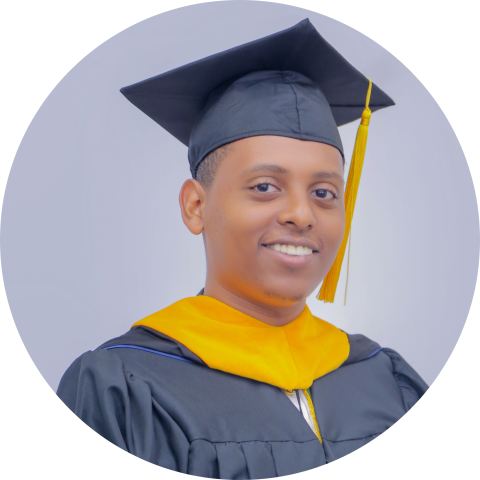 UVA Data Science MSDS student Brook Tarekegn in his cap and gown with yellow sash