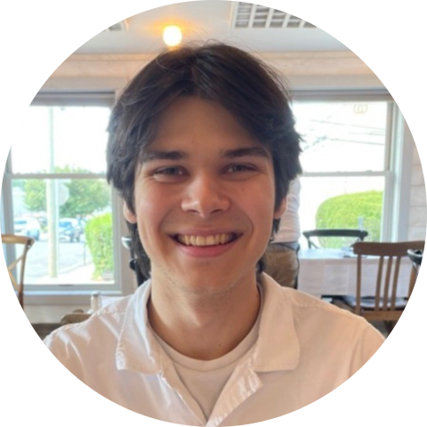 UVA Data Science MSDS online program Ambassador sitting in a restaurant wearing a white shirt