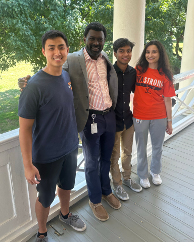 Three UVA MSDS residential students pose on Grounds with Program Director, Professor Prince Afriyie