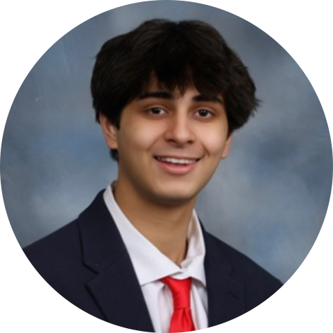 Headshot of Zach Hasan wearing a suit and red tie.