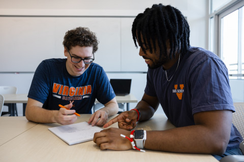 Two UVA Data Science MSDS students work togehter at a table