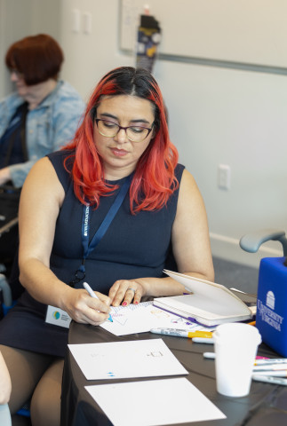 Photo of MSDS student Andrea Jacobs as she visualizes data science through art.