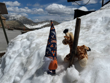 Mascots Boo and Spirit in the snow on Rockies bike trip