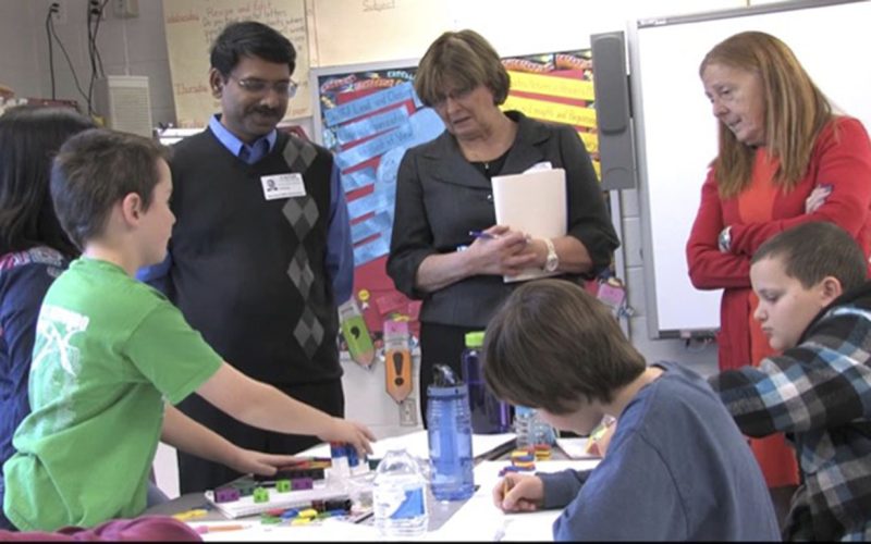 Padhu Seshaiyer, teachers and elementary school students discuss STEM projects.