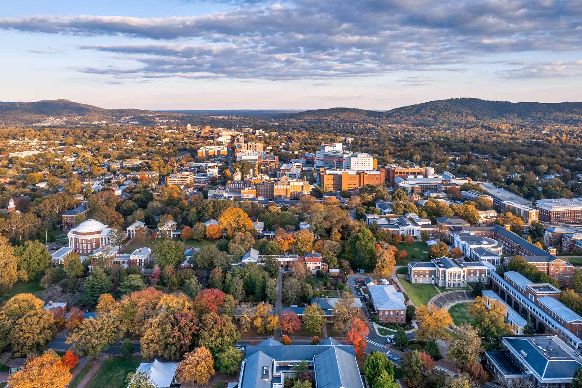 Birdshot view of UVA, autumn colored trees, and various buildings.
