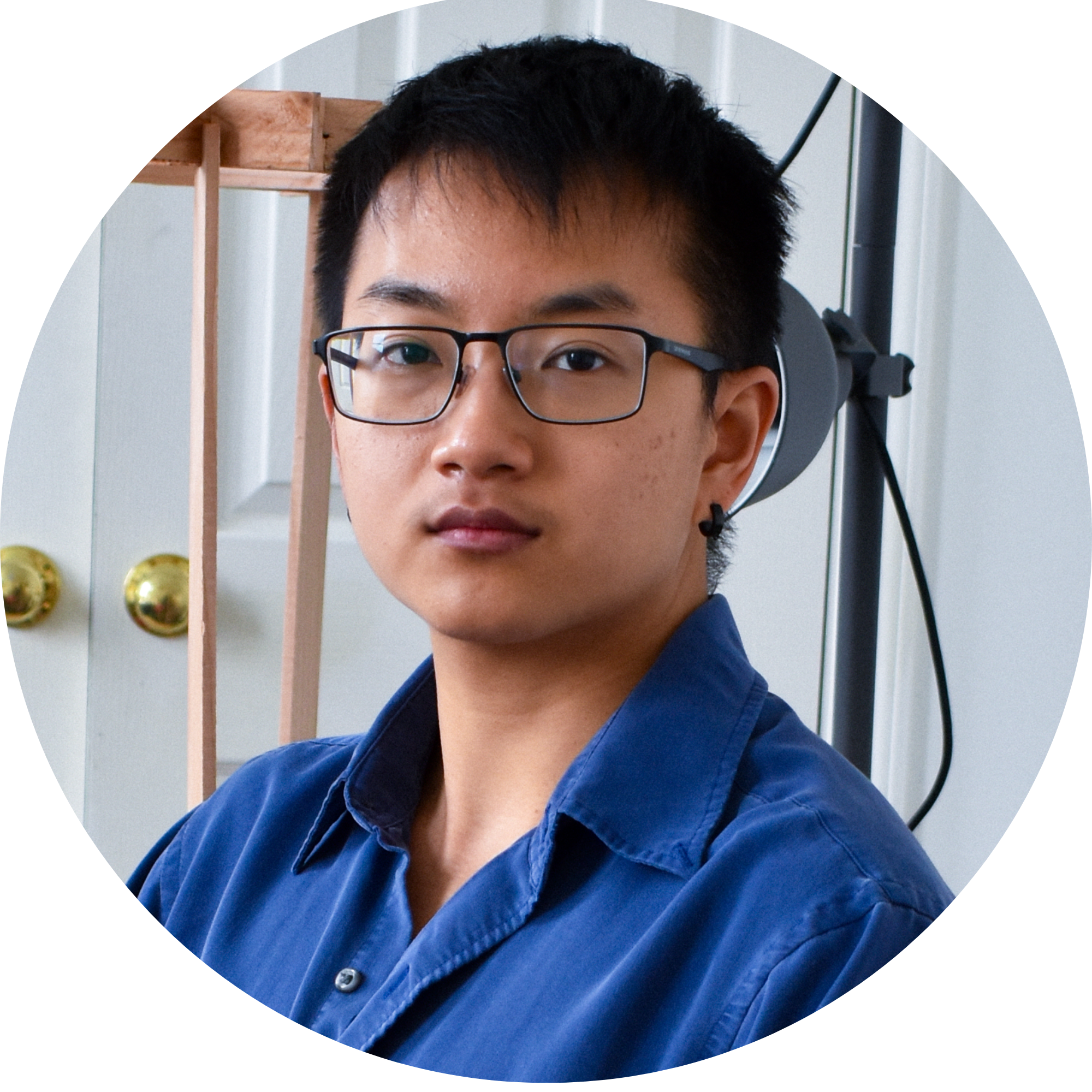 Headshot of Ranger Liu wearing a blue button up shirt and glasses.