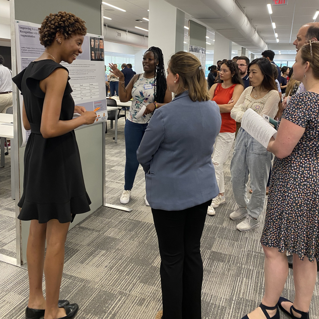 Students, faculty and staff at poster presentation