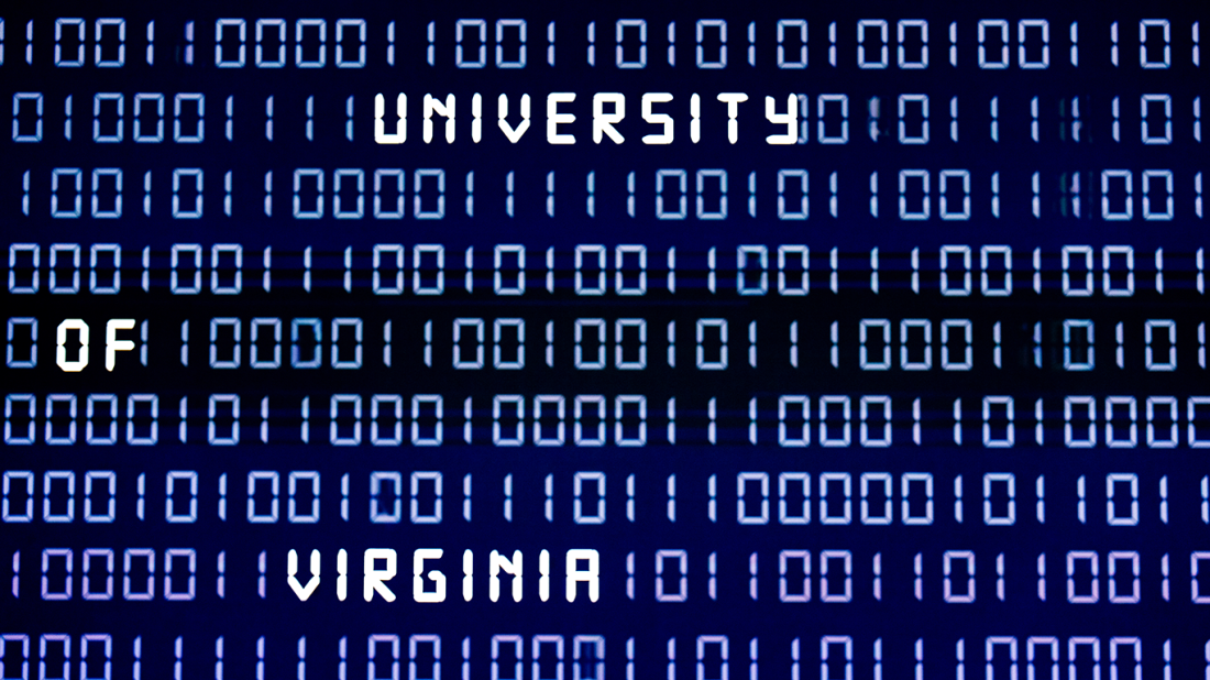 Digital wall display with binary code on a blue background and white letters spelling out University of Virginia