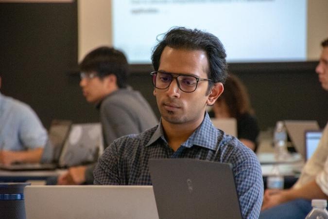 Student in class looking at computer screen