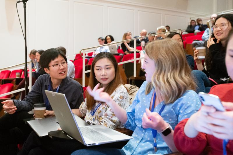 Women conversing in lecture hall