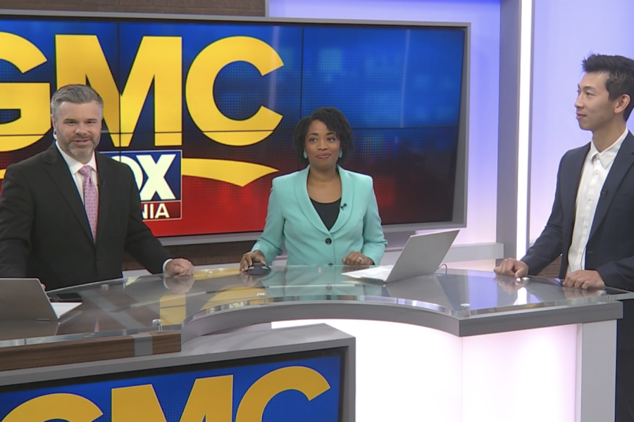 Jason Wang stands with two news anchors for CBS19. 