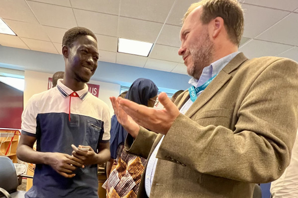 Brandtly Jones, right, speaks with a student during a trip to Abidjan, Côte d'Ivoire, as a member of the U.S. Digital Corps (photo provided by Brandtly Jones).