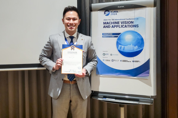 PhD student Kevin Lin poses with award at International Conference on Machine Vision and Applications in Singapore