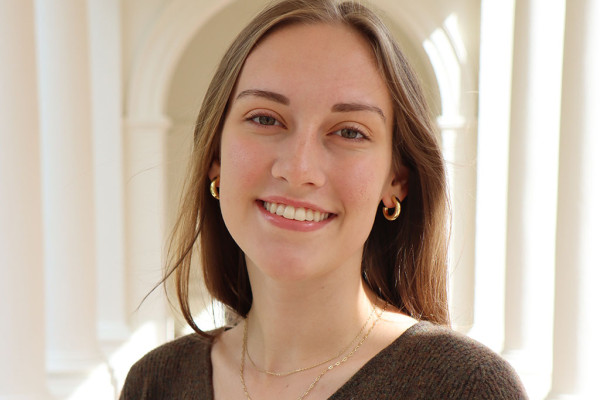 UVA data science msds student Hilde Younce with Rotunda white colonnades behind her