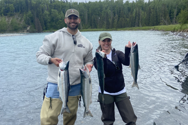 UVA Data Science MSDS online student Cameron Preasmyer salmon fishing, standing in river in Alaska