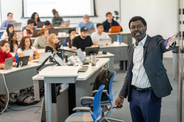 Prince Afriyie talks with students in class.