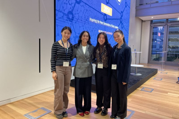 Kayla poses with Miriam Friedel and two other friends in the School of Data Science's Capital One Hub.