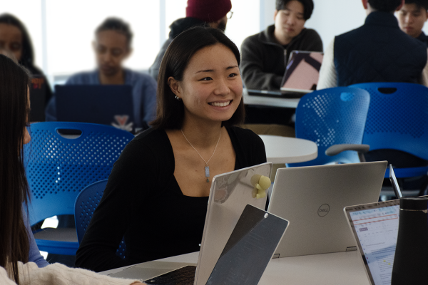 UVA Data Science BSDS student Jia Park in the classroom with students and laptops