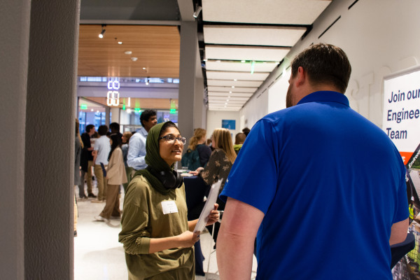 Photo of a student speaking with a recruiter at the Spring 2025 Data Science and Analytics Night.