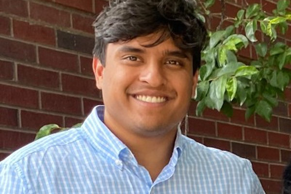 UVA Data Scienec alumni MSDSR 2024 Arnav Bopuddi head shot taken outside in front of tree and brick wall