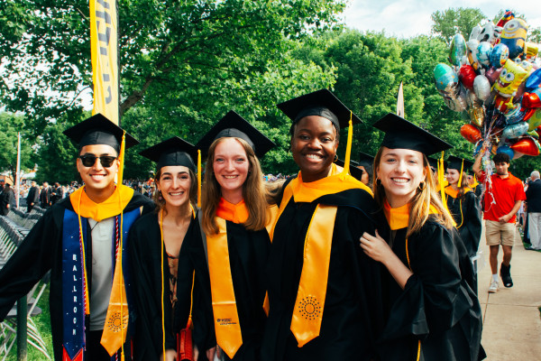 Five UVA Data Science graduates in cap and gown on the Lawn during Final Exercises