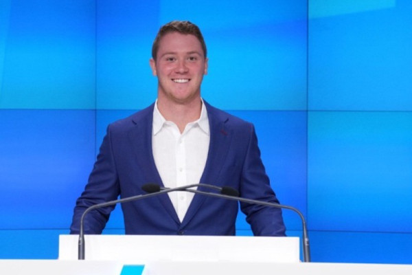 UVA Data Science MSDS online student Addison Nitto at the Nasdaq with Microsoft logo behind him
