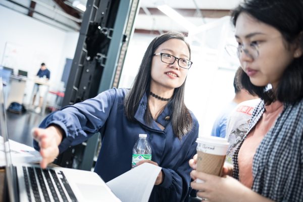 Women discussing by laptop